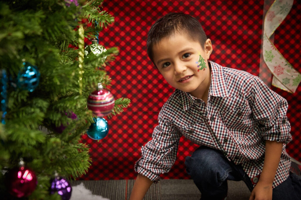 Child by Tree; Adopt-A-Family photo from previous year